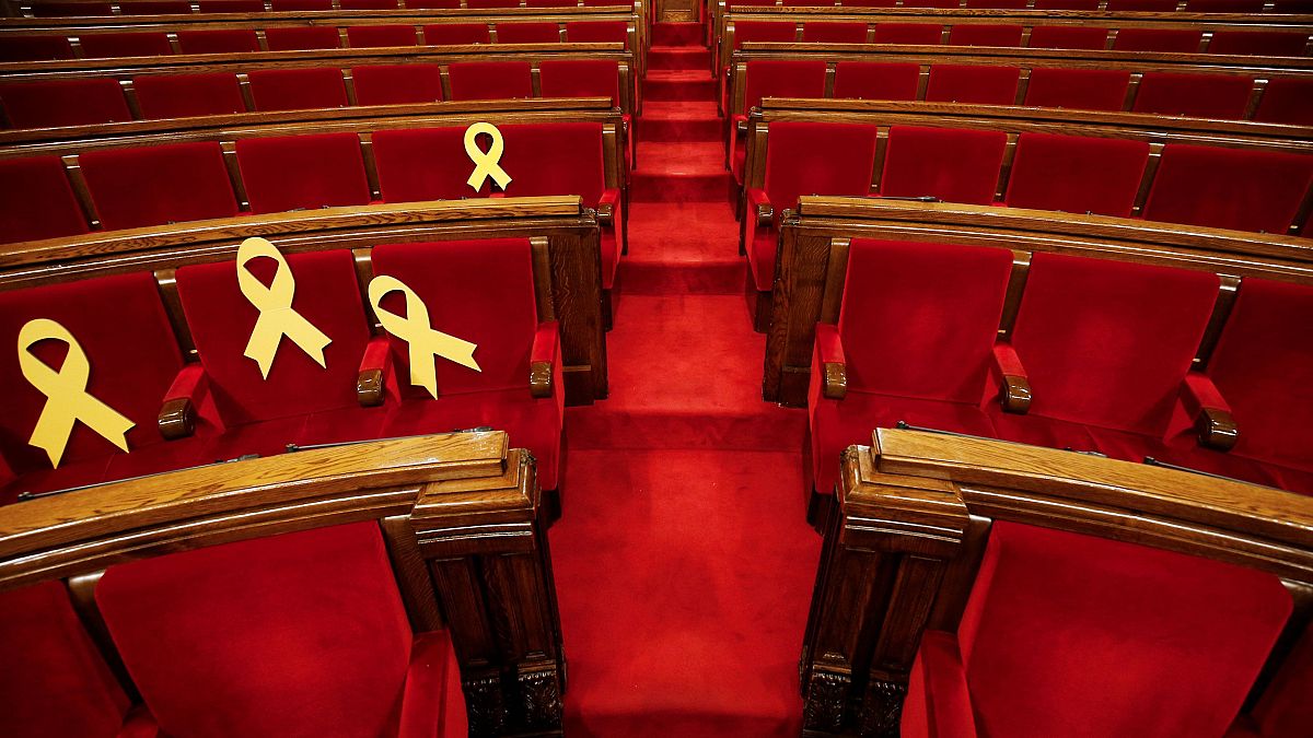 Ribbons on seats of imprisoned deputies at Catalonia’s parliament, March 24