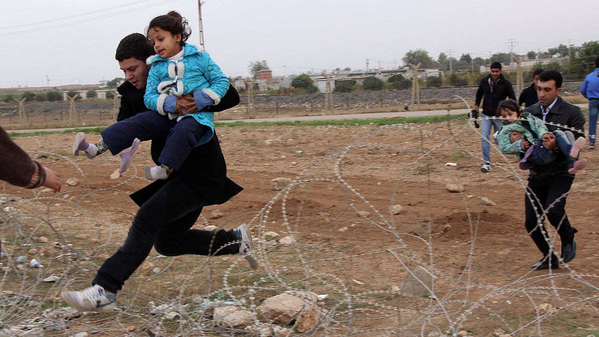 File photo: Syrians flee from the town of Ras al-Ain to Turkey in 2012
