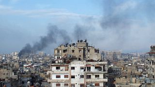 FILE PHOTO: Smoke rises from one of the buildings in the city of Homs
