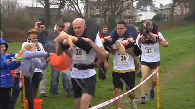 Couples face slips and tricks in UK wife-carrying champs