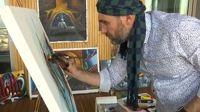 Police officer Ahmet Sula prefers painting to bullets