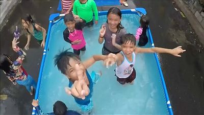 Filipinos have pool party on the street to cool off