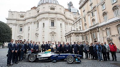 Pope Francis poses next a Formula-E electric racing car