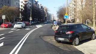 Polish pragmatism: city tarmacs around car blocking road renovation