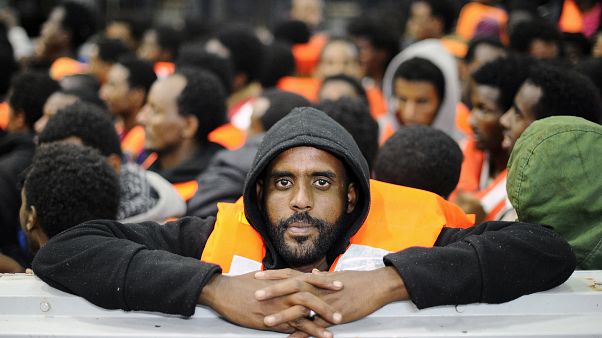 Sub-Saharan migrants stand on an Italian rescue boat in 2014. Sub-Saharan migrants stand on an Italian rescue boat in 2014.