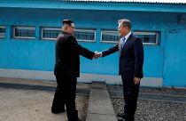Kim Jong Un and Moon Jae-In shake hands over the border in April 2018