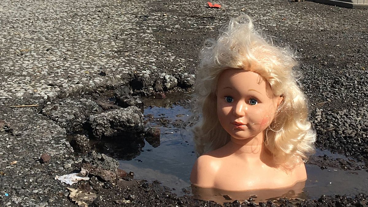 Dolls' heads pop up in UK potholes in repair plea