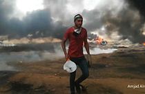 Watch: Protesters use tennis rackets to bat away tear gas