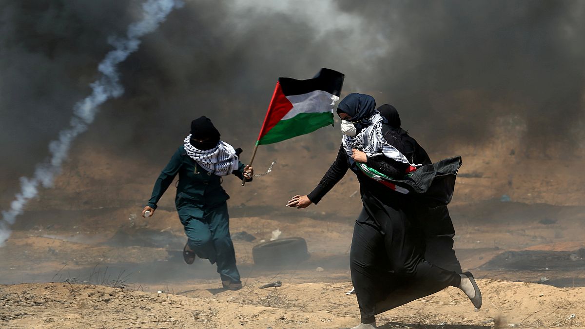 Female Palestinian protests run for cover