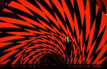 Michael Schulte singt beim ESC-Semifinale vor rot-schwarzem Hintergrund