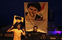 portraits of Shi'ite cleric Moqtada al-Sadr