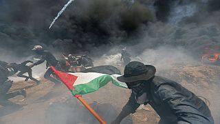 Palestinian demonstrators gather at the Israel-Gaza border