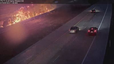 Fiery dump truck crash as car attempts to backup on highway