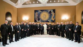 Pope Francis poses with Chile's bishops after a Vatican meeting