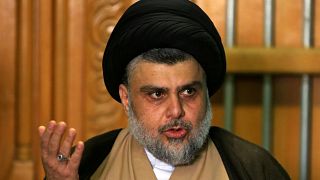 Shia cleric Moqtada al-Sadr speaking at a news conference