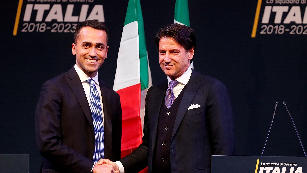 5-Star Movement leader Di Maio shakes hands with Giuseppe Conte