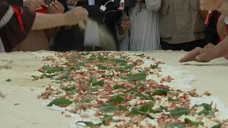 Adding the final touches before the record breaking pizza was fried