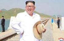 Kim Jong-un wears snappy white shirt, straw hat to inspect railway