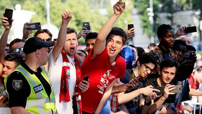 Liverpool fans greet the team arriving at their hotel