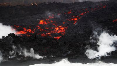 Lava pours into the ocean during the eruption of the Kilauea Volcano