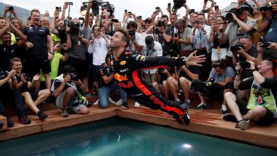 Red Bull's Daniel Ricciardo jumps into a pool 