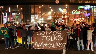 People attend a protest in support of the truck drivers' strike in Canoas