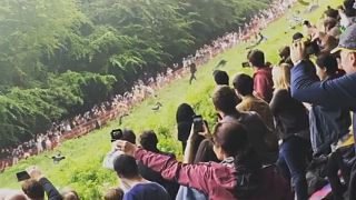 Watch: Competitors tumble down hill at annual UK cheese-rolling race