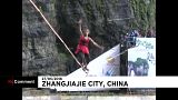 A woman walks a highwire in high-heels