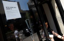 A sign in the window of a door of a Starbucks