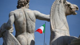 The Italian flag waves over the Quirinal Palace in Rome