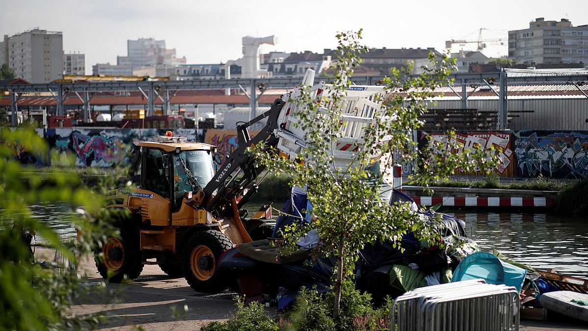 Police brought in bulldozers to help clear a migrant camp in Paris