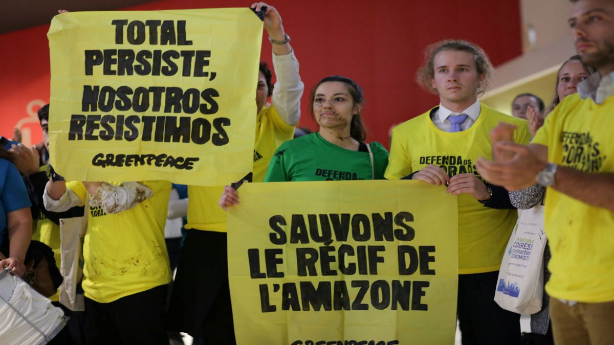 Greenpeace activists protest during Total's annual shareholders meeting