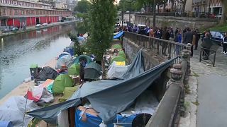 Police move migrants from makeshift camp by Canal St Martin in Paris