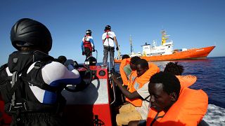 Migrants on a rubber boat are rescued by the SOS Mediterranee