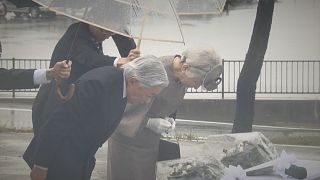 Japan'`s Emperor Akihito and Empress Michiko pay respects to tsunami victims