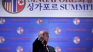 Trump points during a news conference after his summit with Kim Jong-un