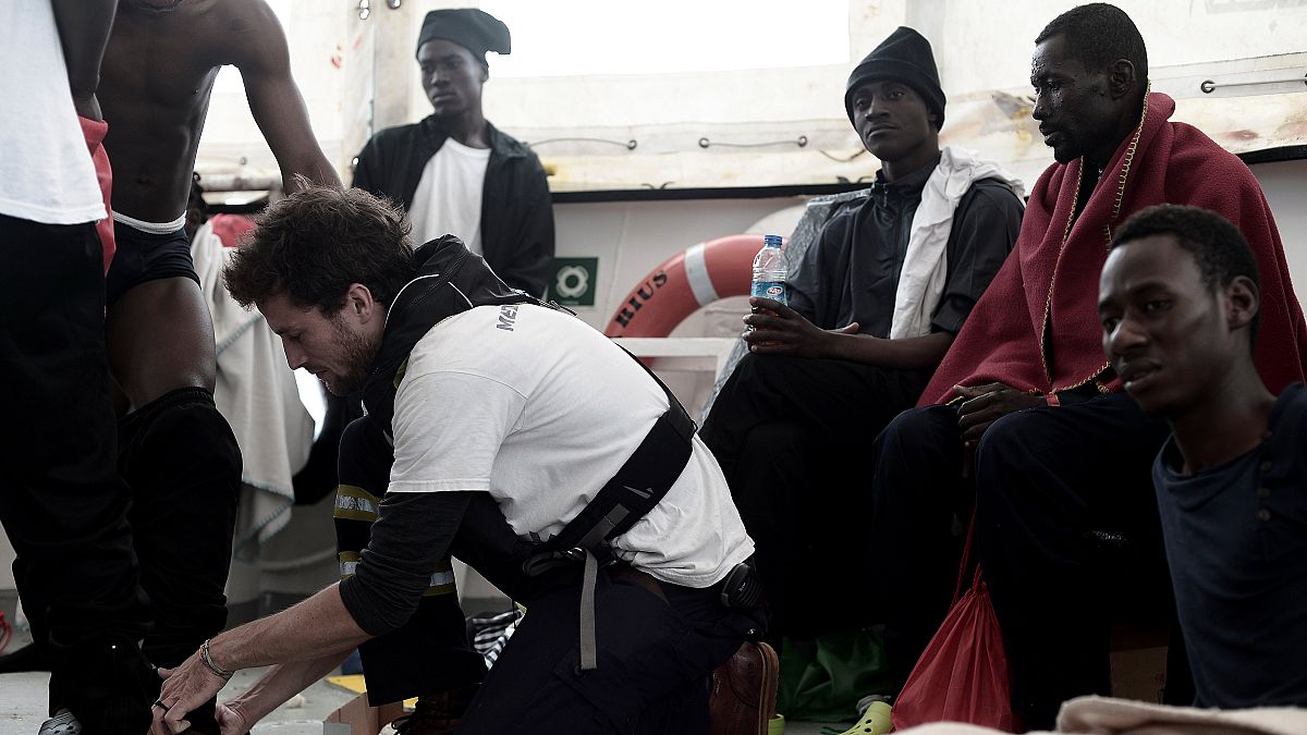 A staff member checks the physical condition of a migrant on Aquarius