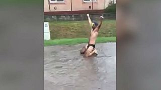 Watch: Man's 'pothole swim' paves way for town's new road after video goes viral