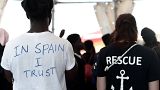 A migrant waits to disembark from the Aquarius