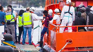 Migrants arrive aboard a Spanish maritime rescue boat