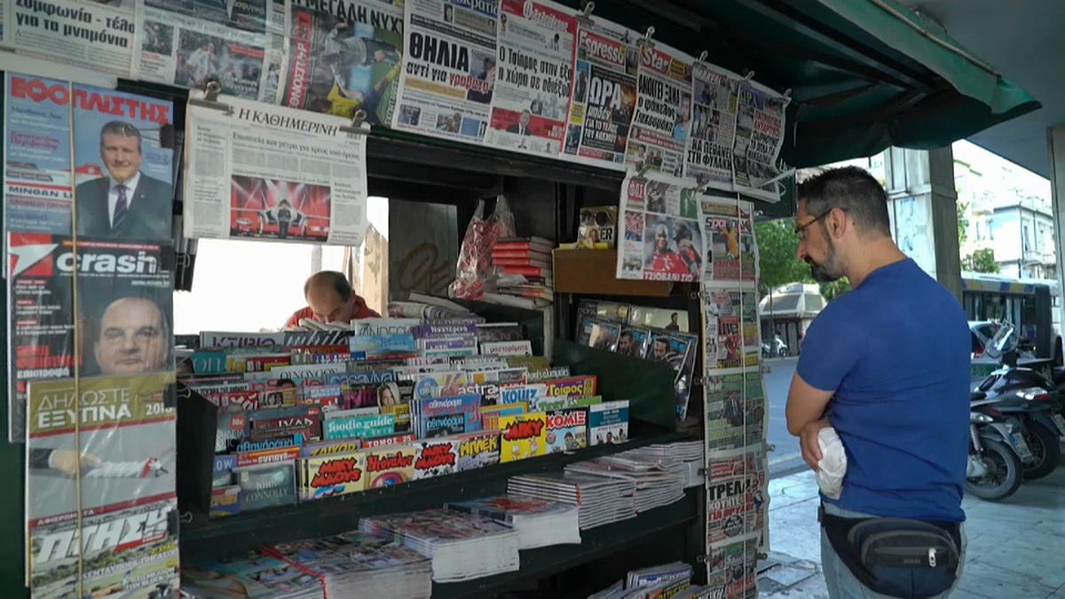 Greek newspapers carrying news of the debt relief deal