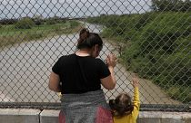 A Honduran mother and daughter seeking asylum wait on the Mexican side of t