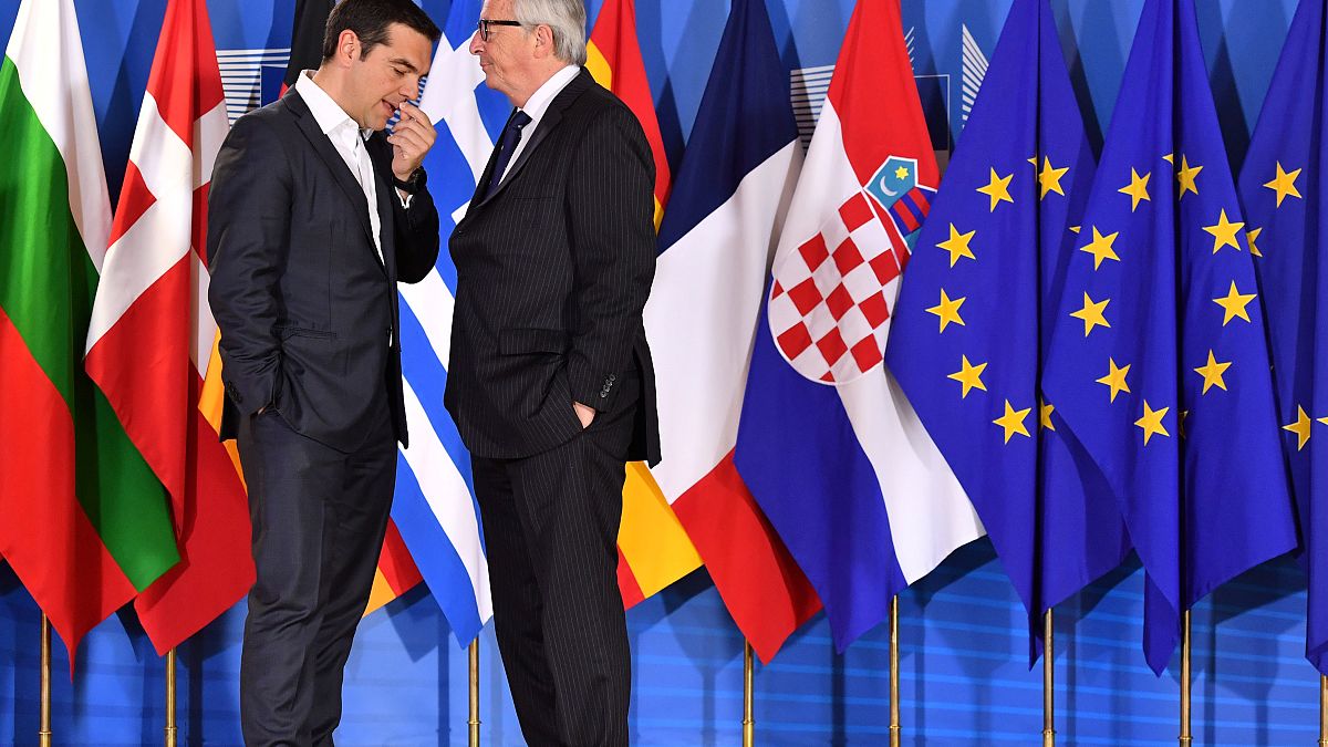 European Commission President Jean-Claude Juncker speaks with Greek Prime M