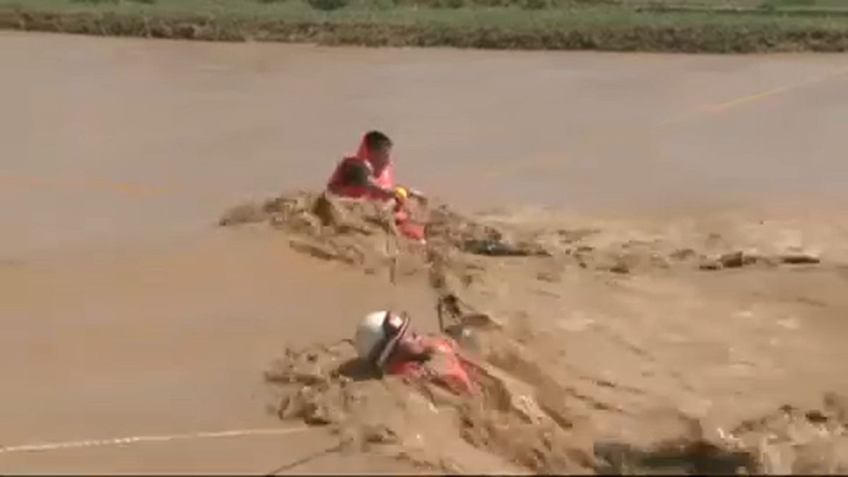 نجات زوج چینی از میان سیلاب