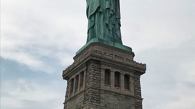 Watch: protester removed from Statue of Liberty after immigration demo