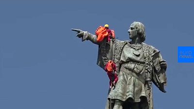 Activists place life jacket on Christopher Columbus statue in Barcelona