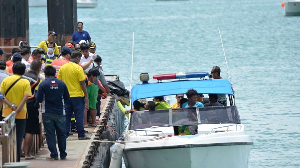 Rescue workers carry a body recovered from the scene Rescue workers carry a body recovered from the scene