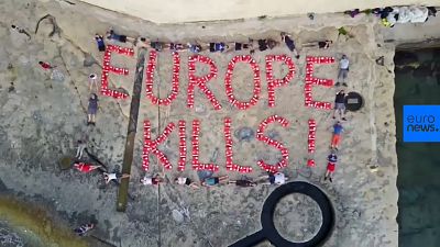 Activists spell 'Europe kills' with life jackets after migrant vessel seized