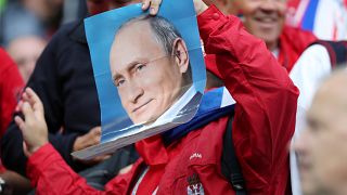 Where's Putin? Serbia fan holds a photo of the Russian leader at World Cup