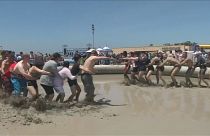 Revellers jump into sludge at South Korea's annual mud festival